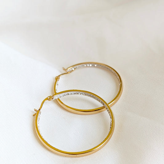 Gold stainless steel hoop earrings with crystal rhinestones on the inside