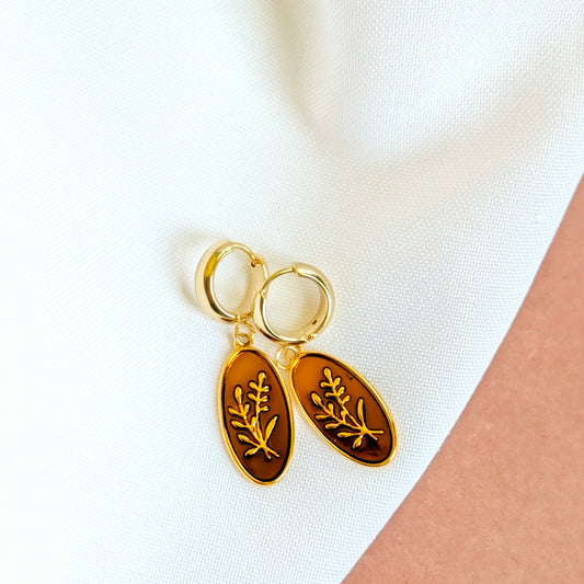 Gold huggie hoop earrings with brown enamel oval charm and gold leaf