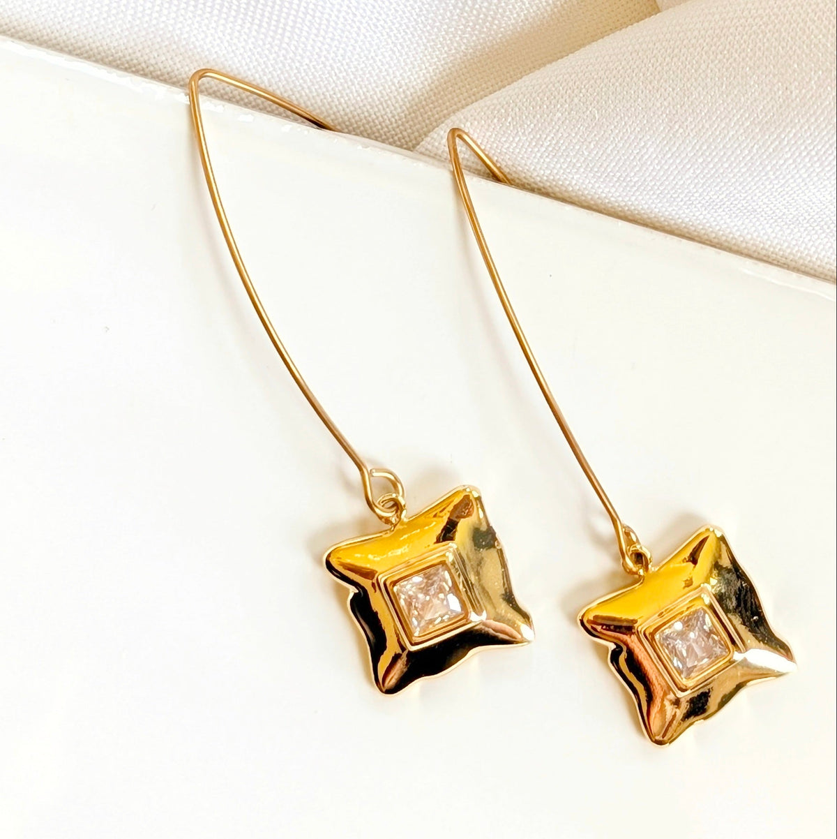 Gold square charm earrings with cubic zirconia on a long ear wire